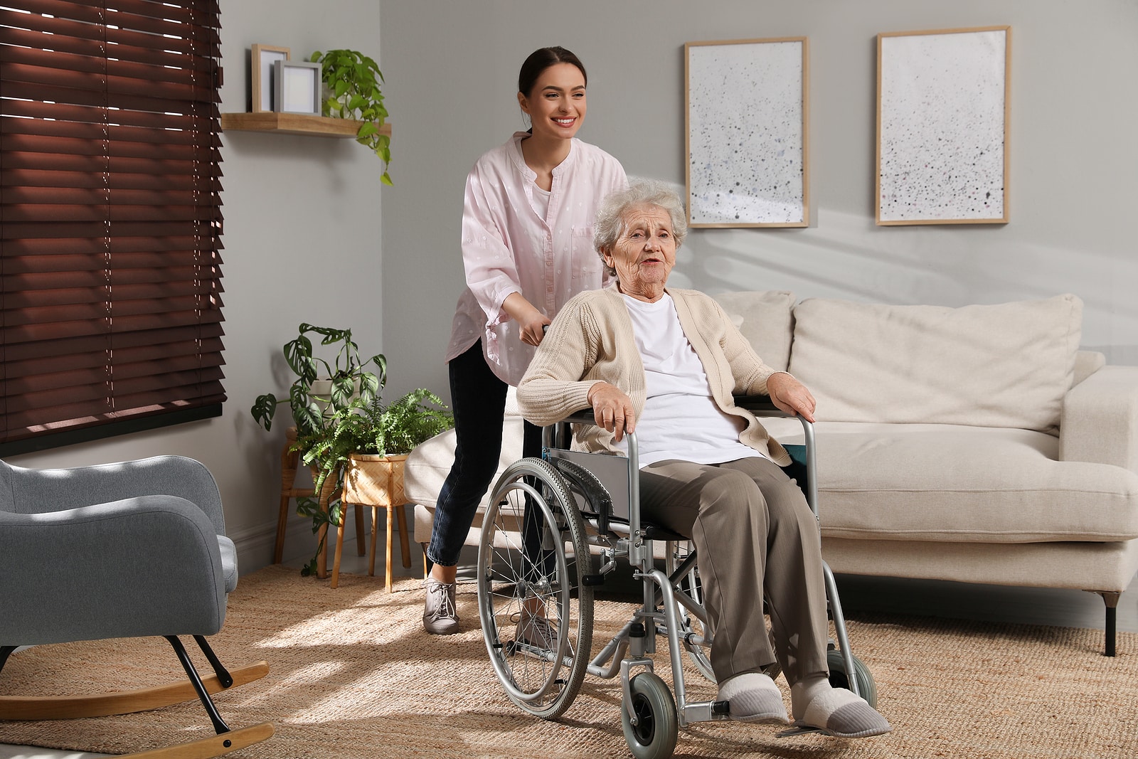Young caregiver assisting senior